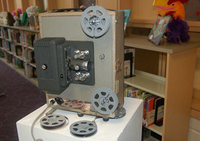 photo of silent movie projector with film reels. 