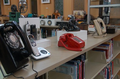 photo of display of the many vintage telephones of the past