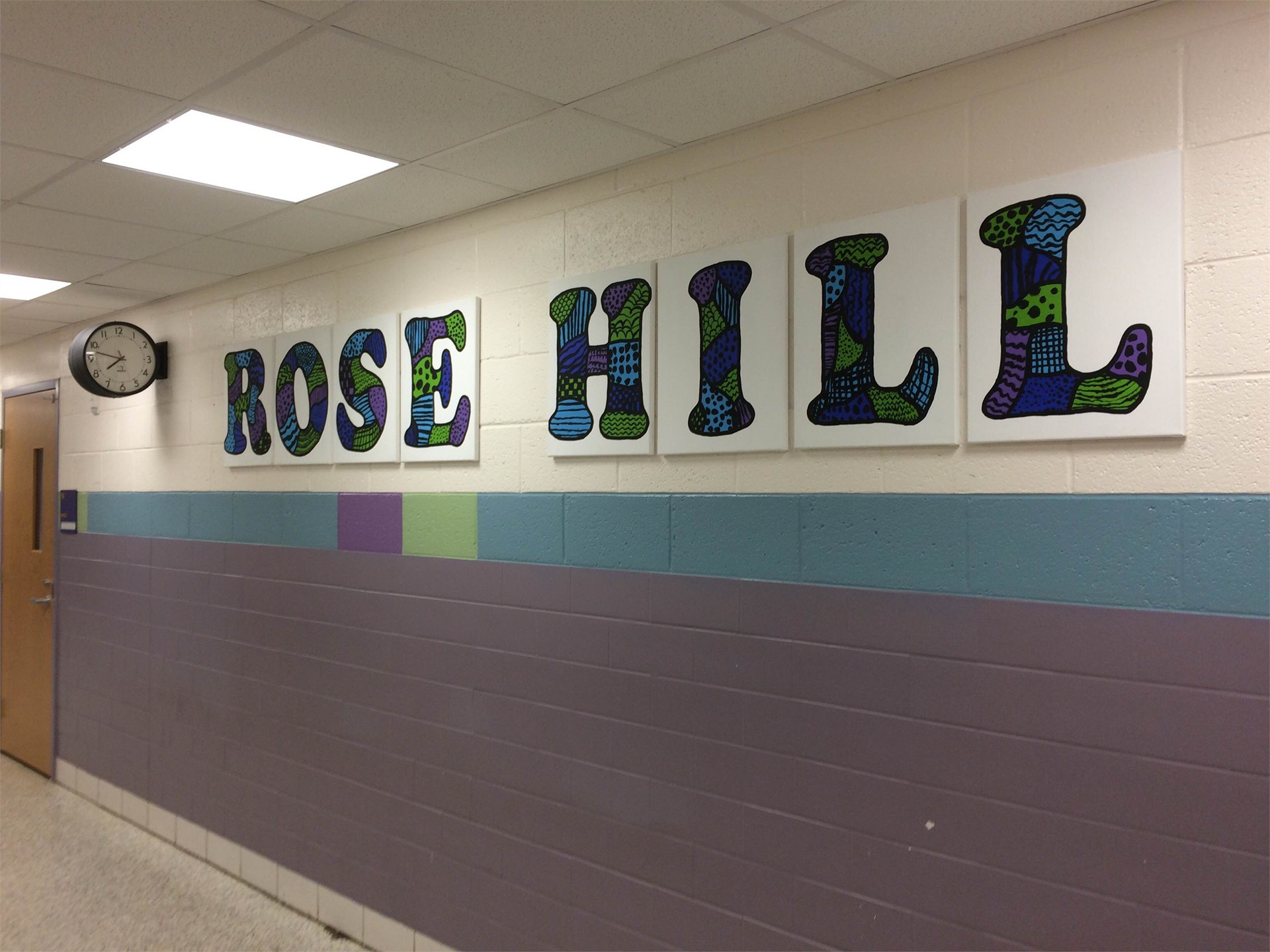 Painted letters that spell Rose Hill