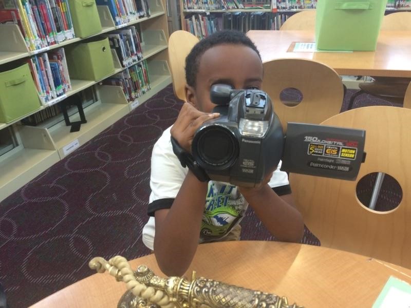 photo of student looking at camera through the lens of a VCR camera.