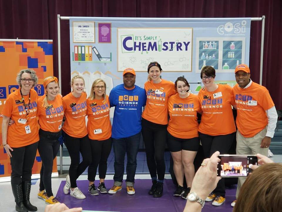 Rose Hill staff in front of event banner