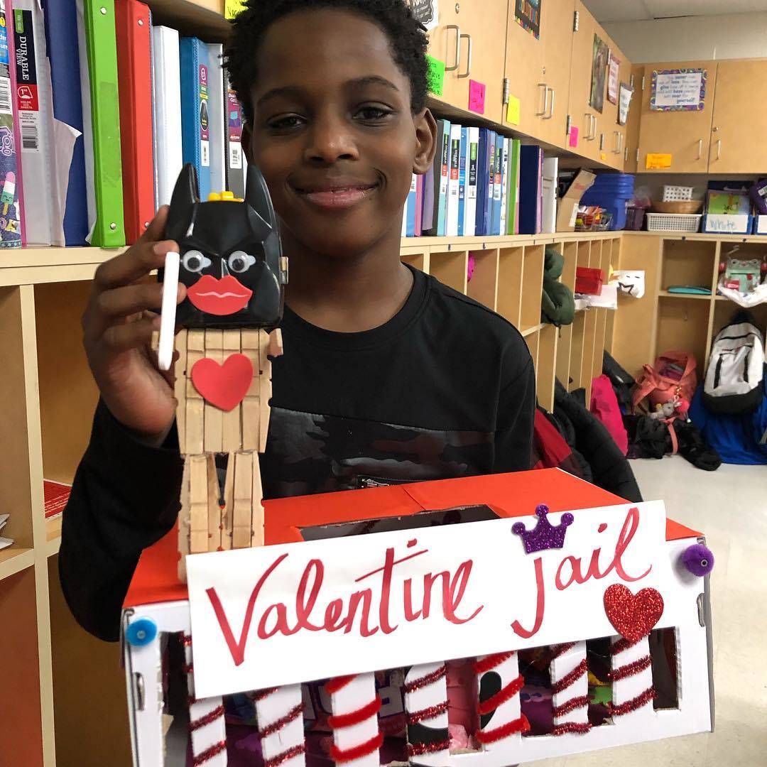 Young boy showing off his Valentine&#39;s Day box