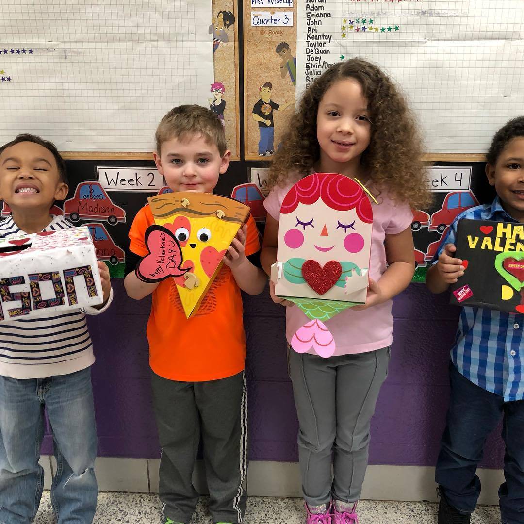 Rose Hill Students showing their handmade Valentine&#39;s boxes