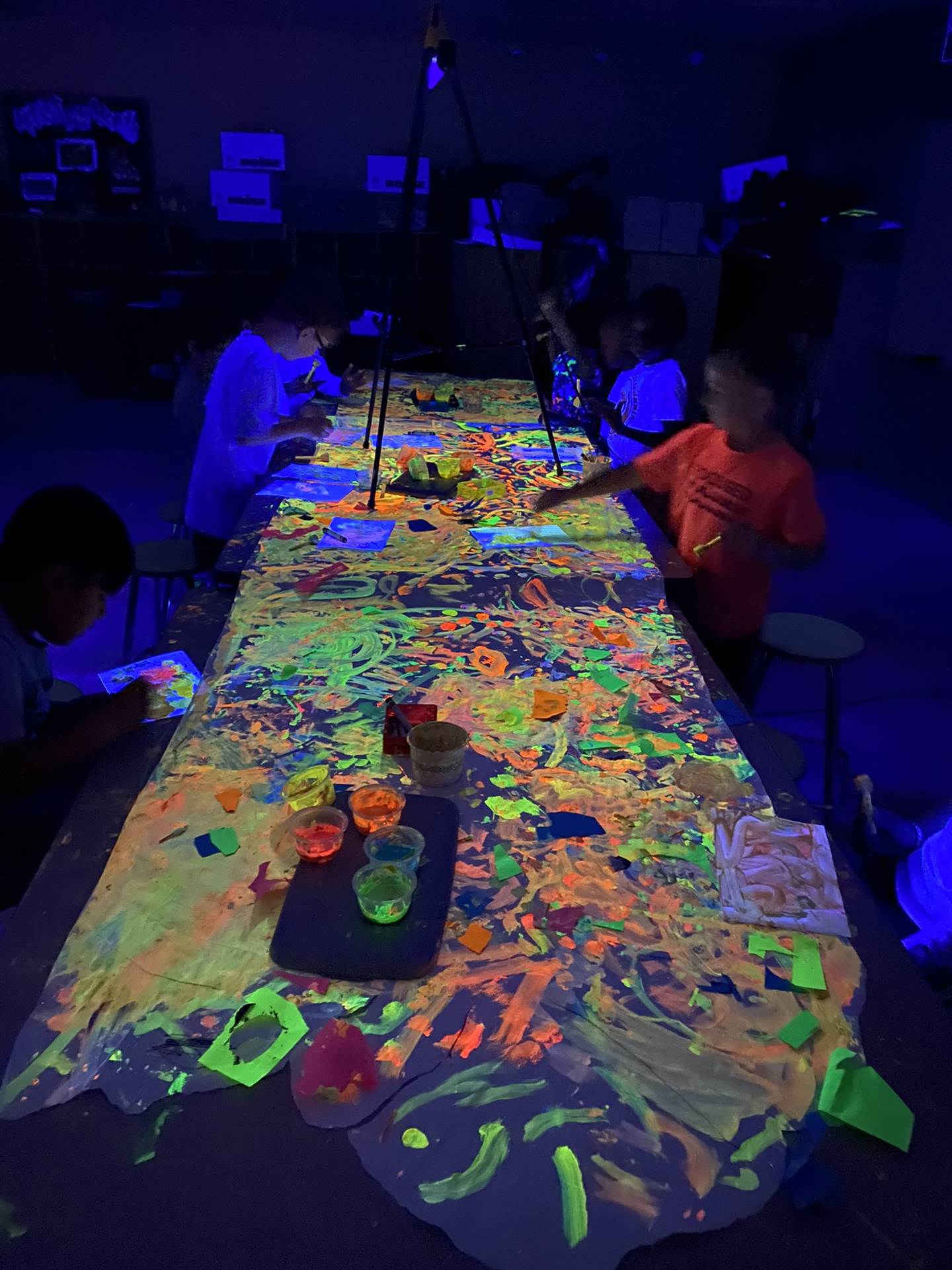 Students playing with glow in the dark paint