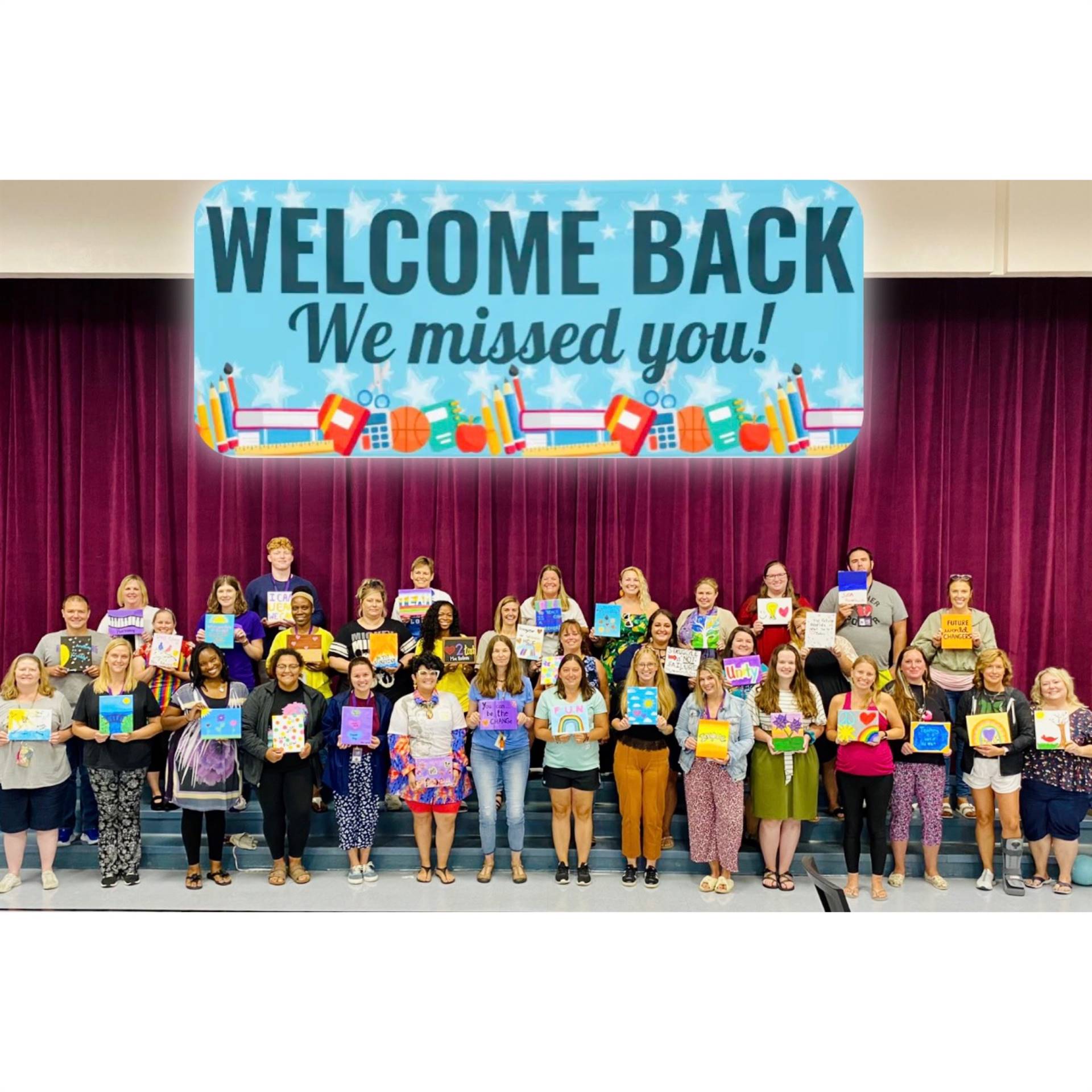 Staff group photo with a banner that says "Welcome back, we missed you."