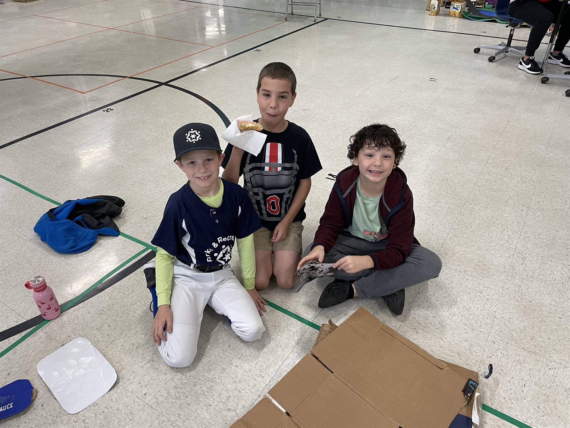 Firebird families in the gymnasium build with cardboard. 