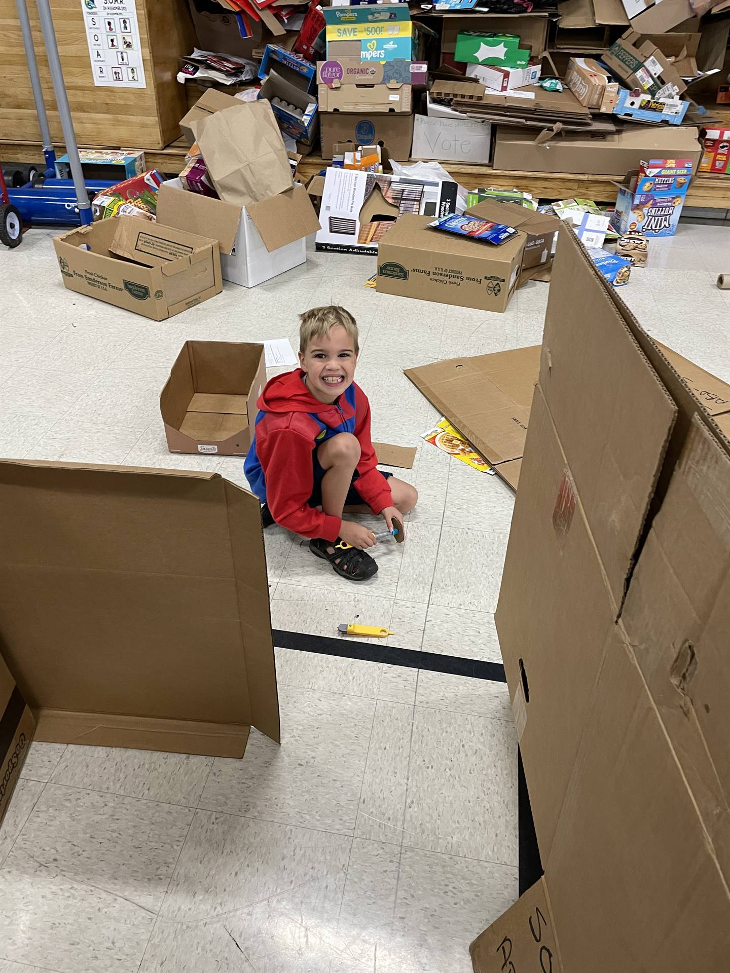 Firebird families in the gymnasium build with cardboard. 