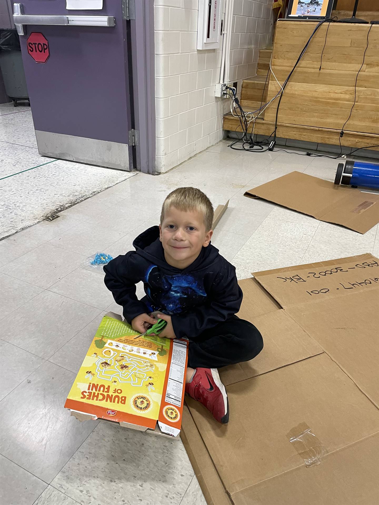 Firebird families in the gymnasium build with cardboard. 