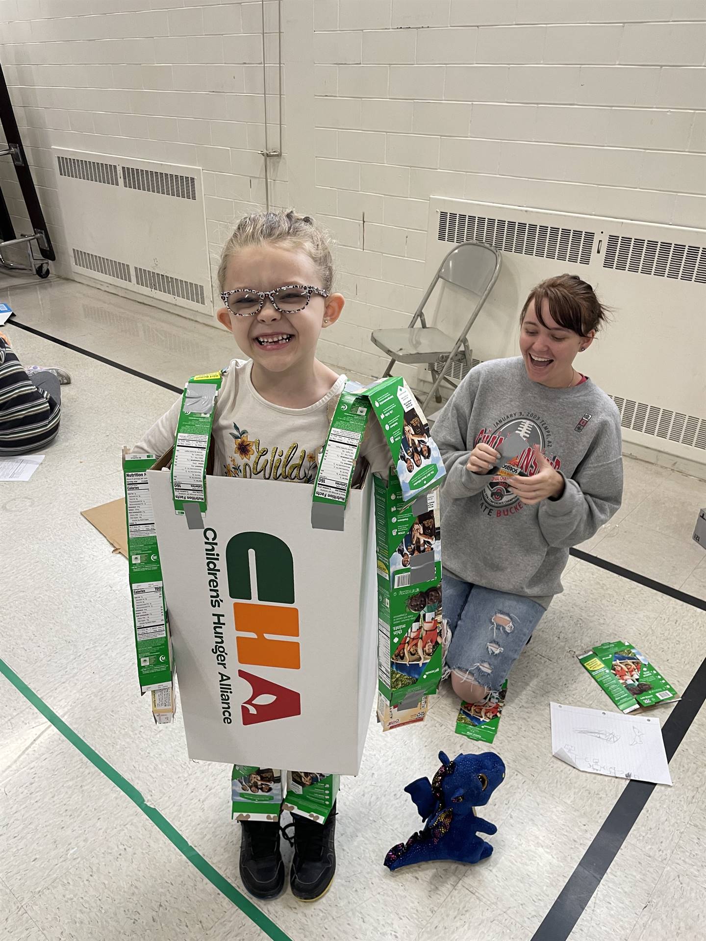 Firebird families in the gymnasium build with cardboard. 