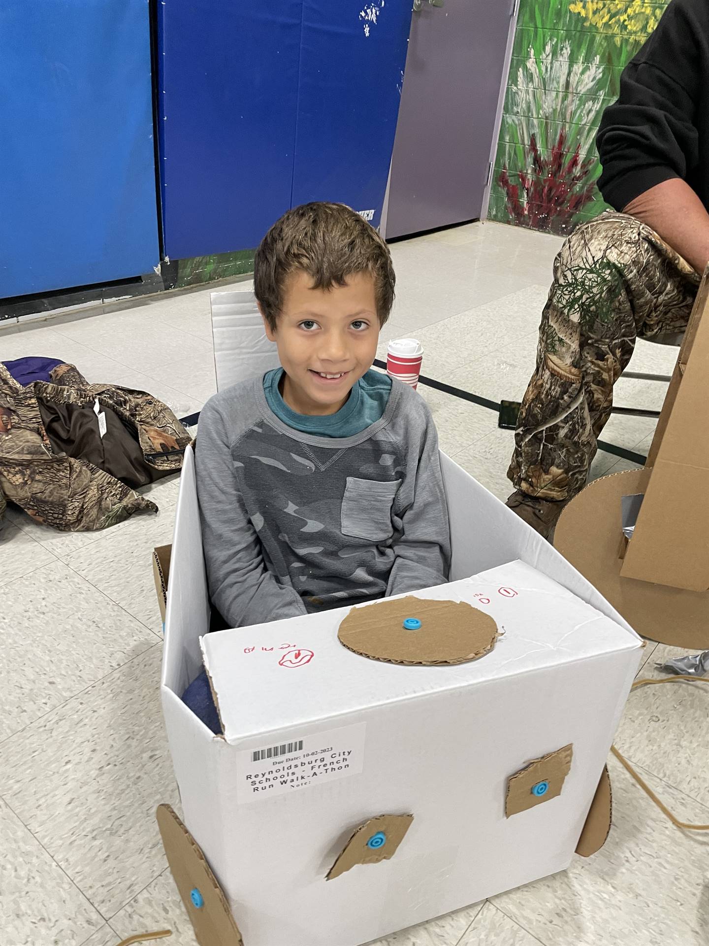 Firebird families in the gymnasium build with cardboard. 