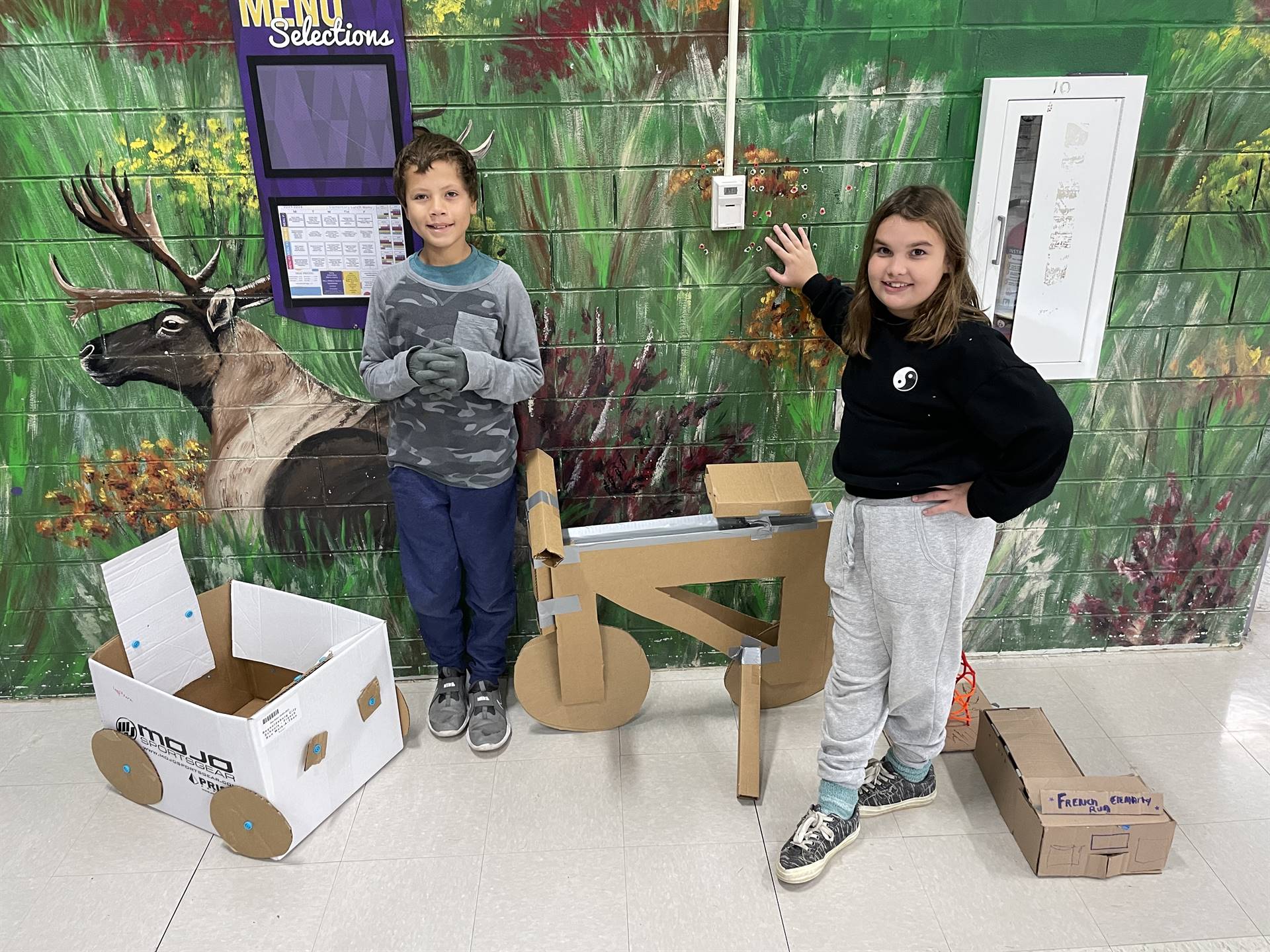 Firebird families in the gymnasium build with cardboard. 
