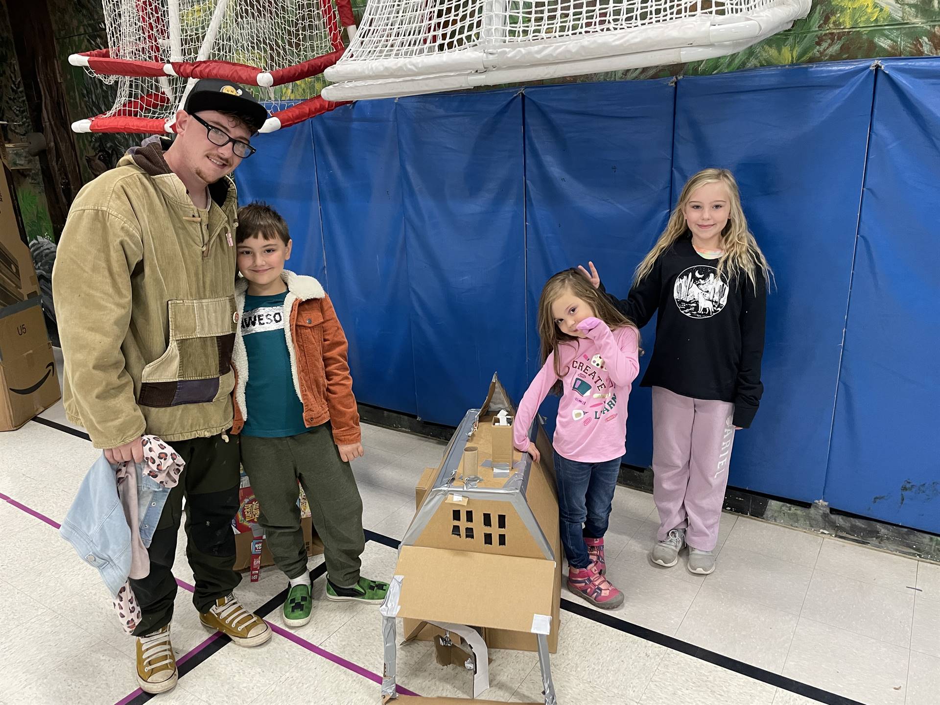 Firebird families in the gymnasium build with cardboard. 