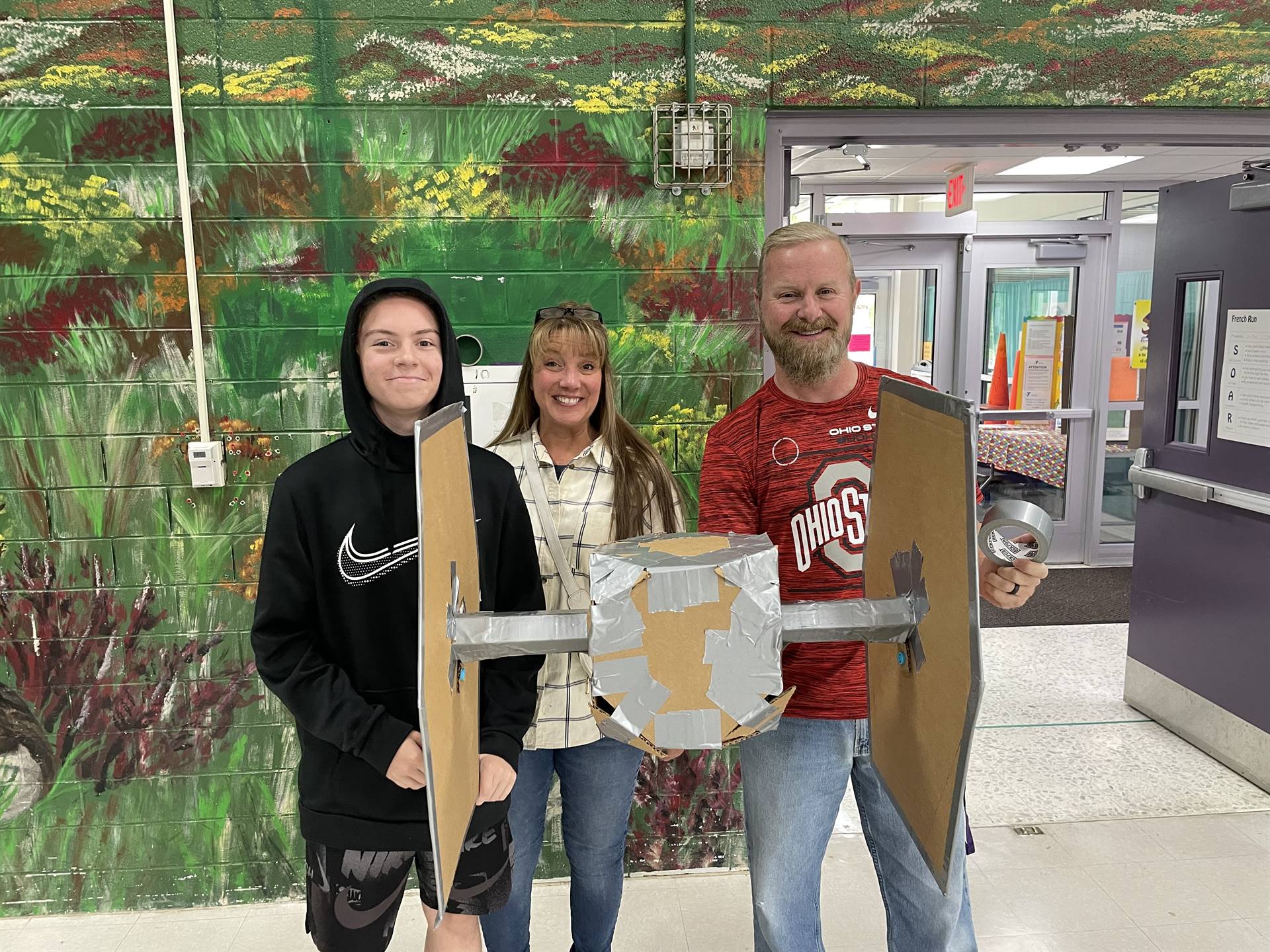 Firebird families in the gymnasium build with cardboard. 