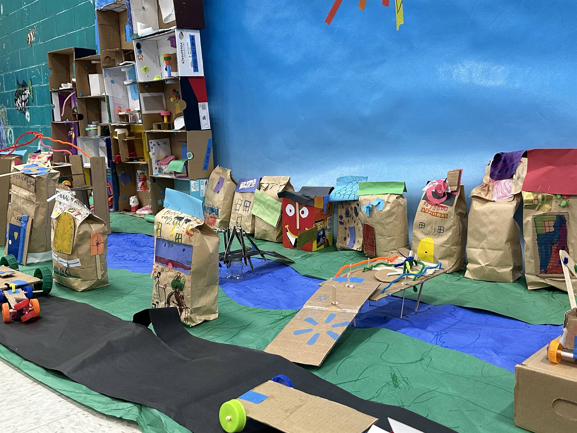 Firebird families in the gymnasium build with cardboard. 