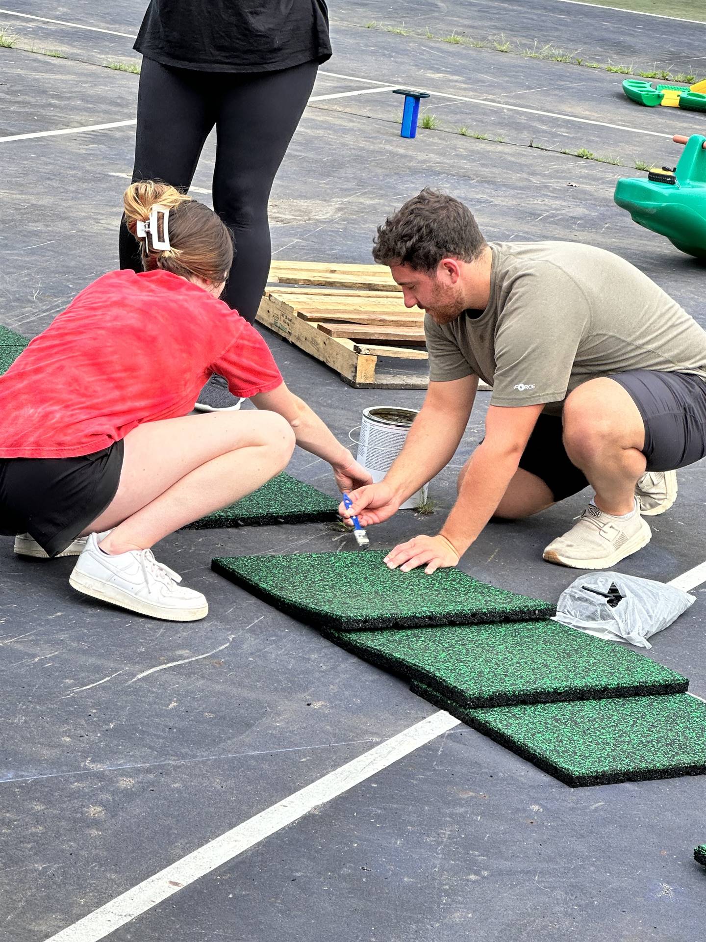 Staff working on the playground tiles