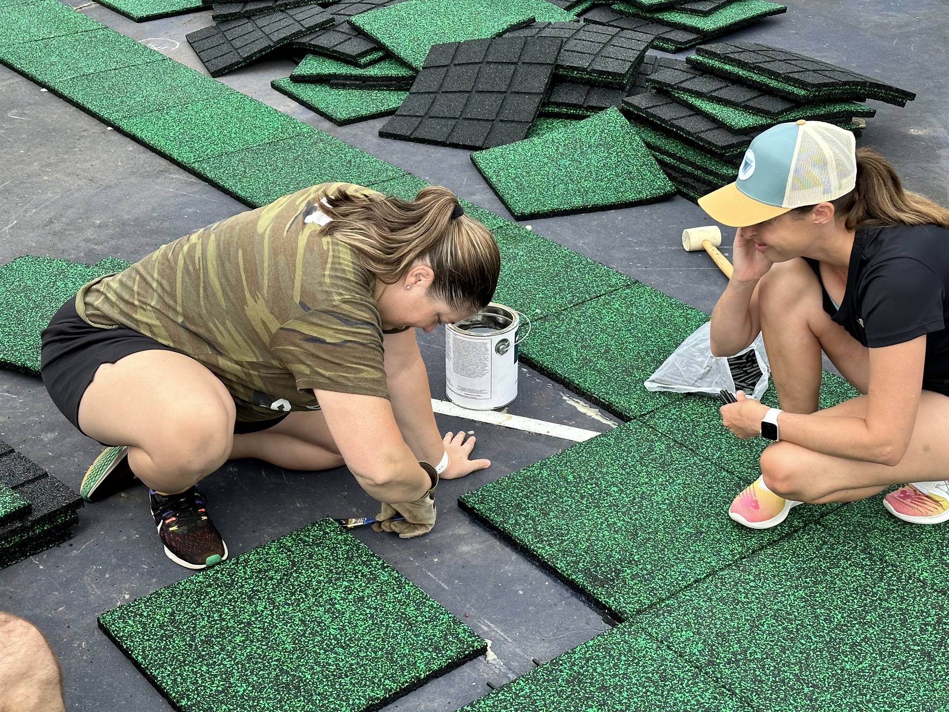 Staff working on the playground tiles