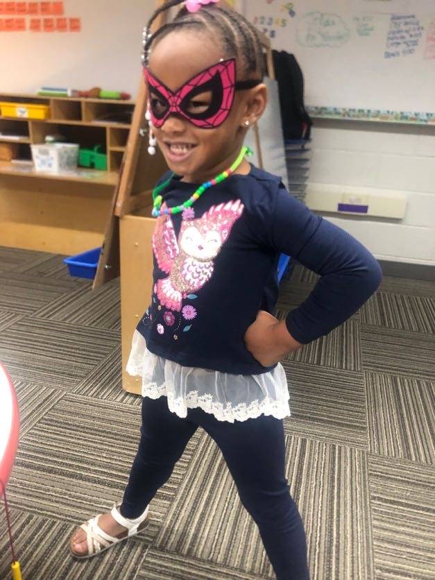 Little girl dressed as superheros