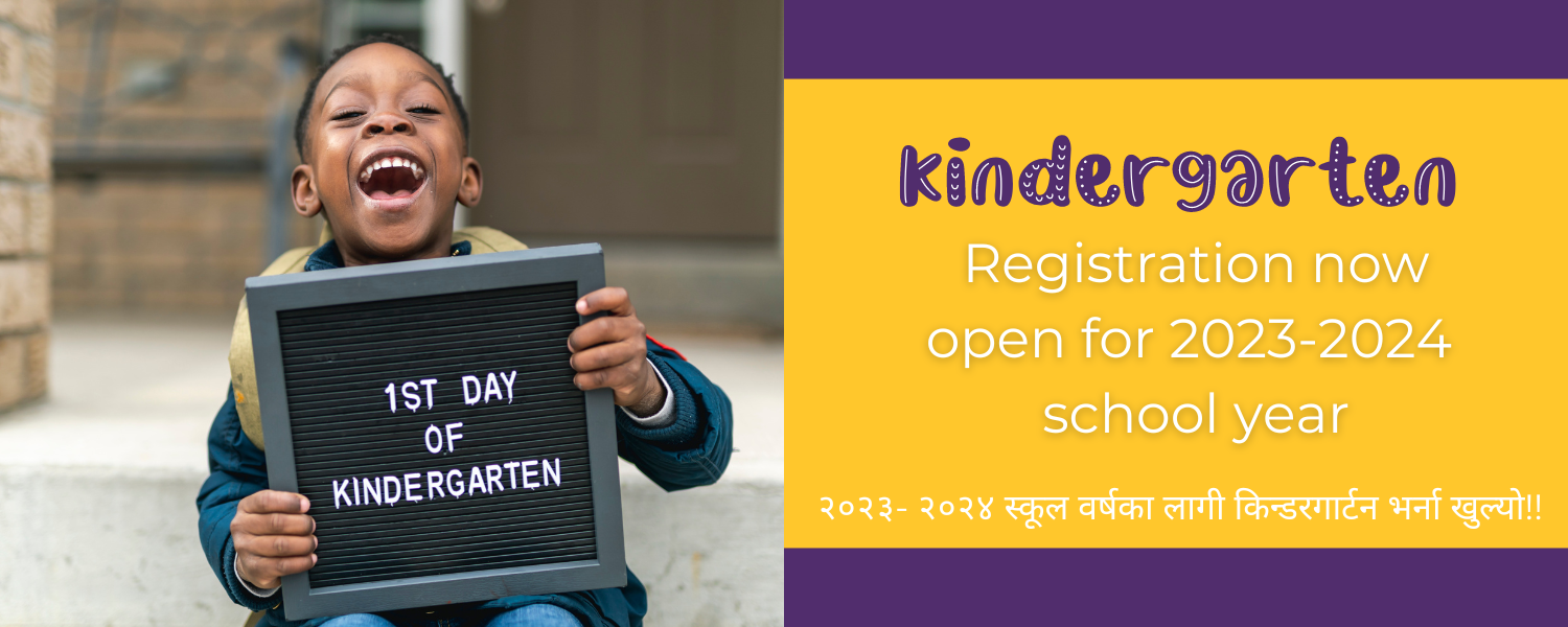 Young boy holds a sign for 1st Day of Kindergarten