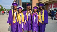 Graduates pose outside arena before ceremony