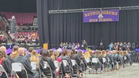 Graduates and faculty are seated while speaker is on podium