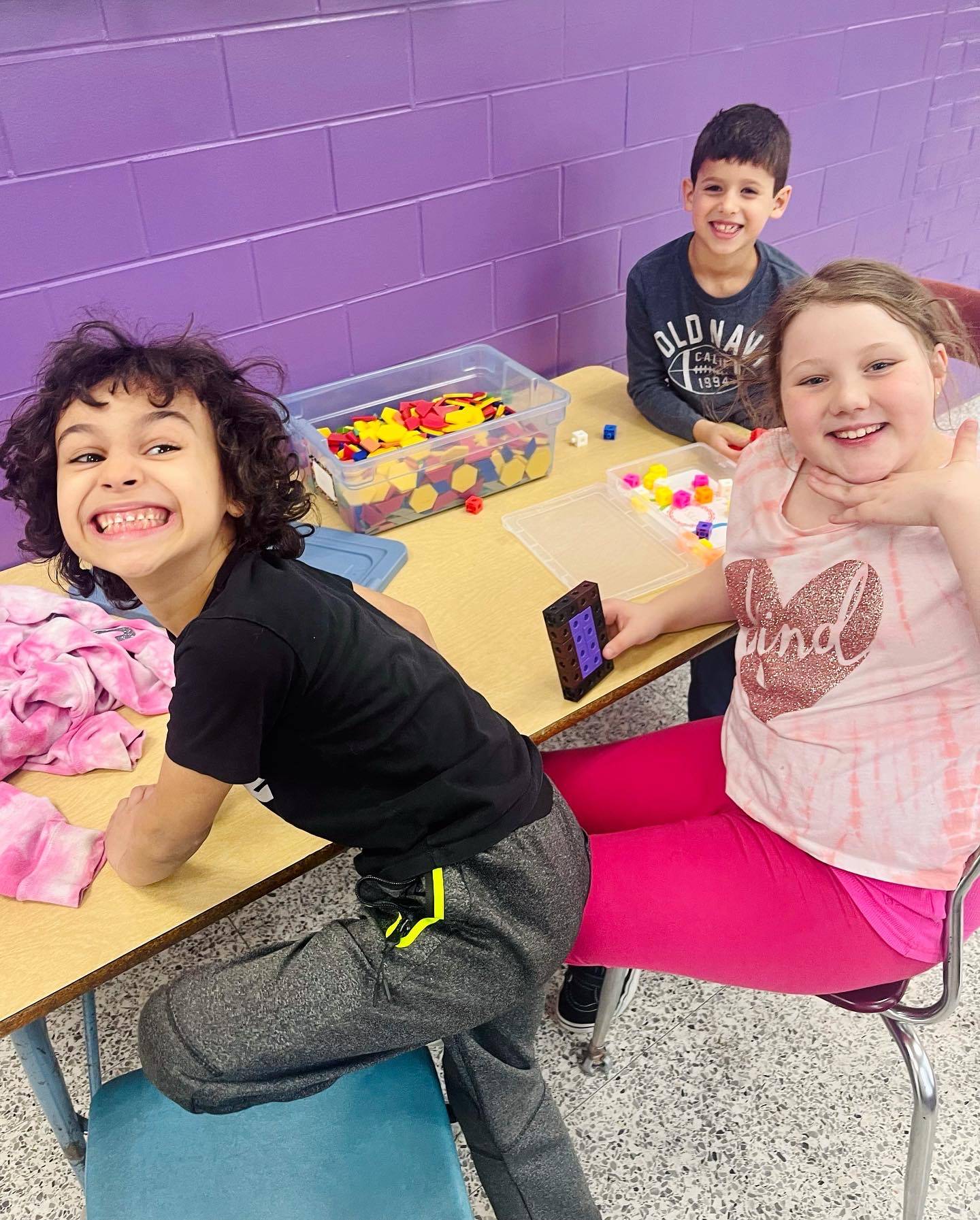 Students at a table smiling