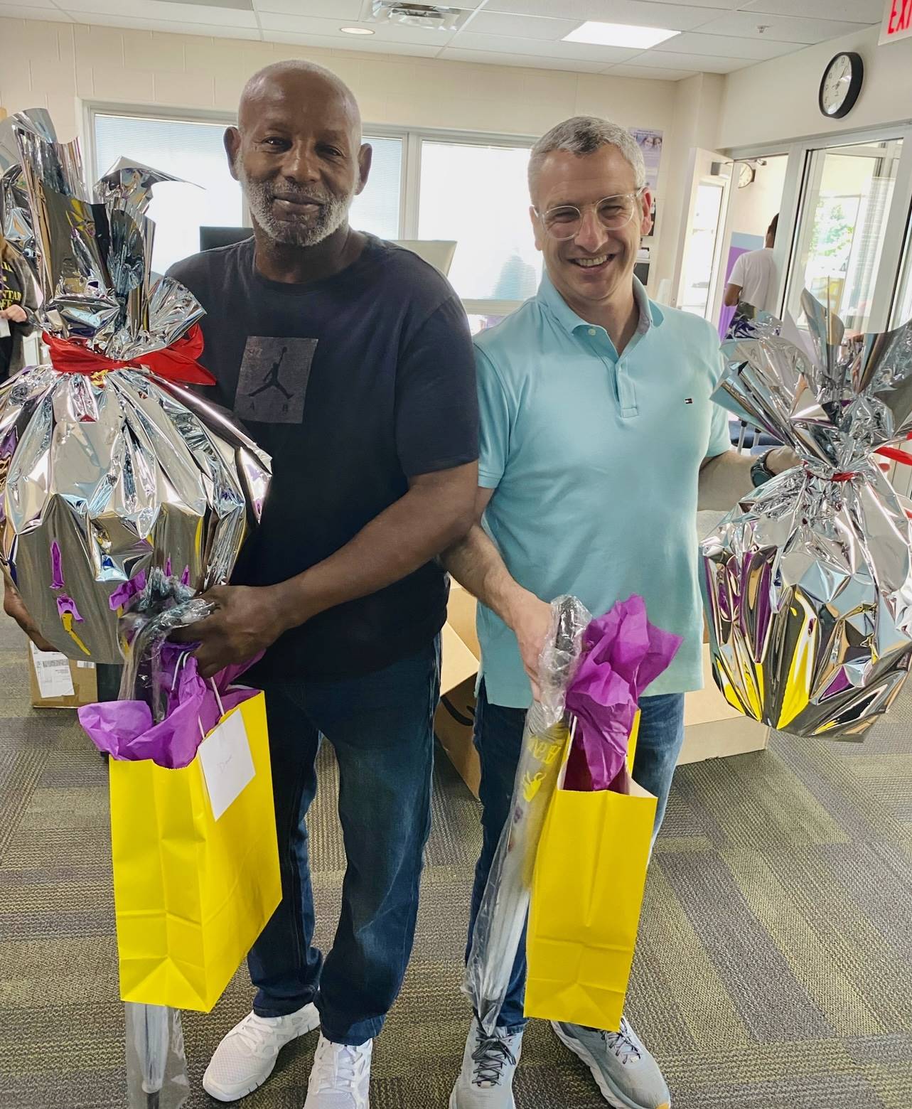 Two men holding gift bags