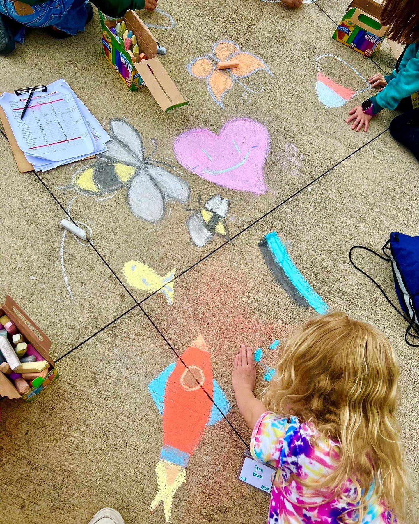 Children drawing on the sidewalk with chalk