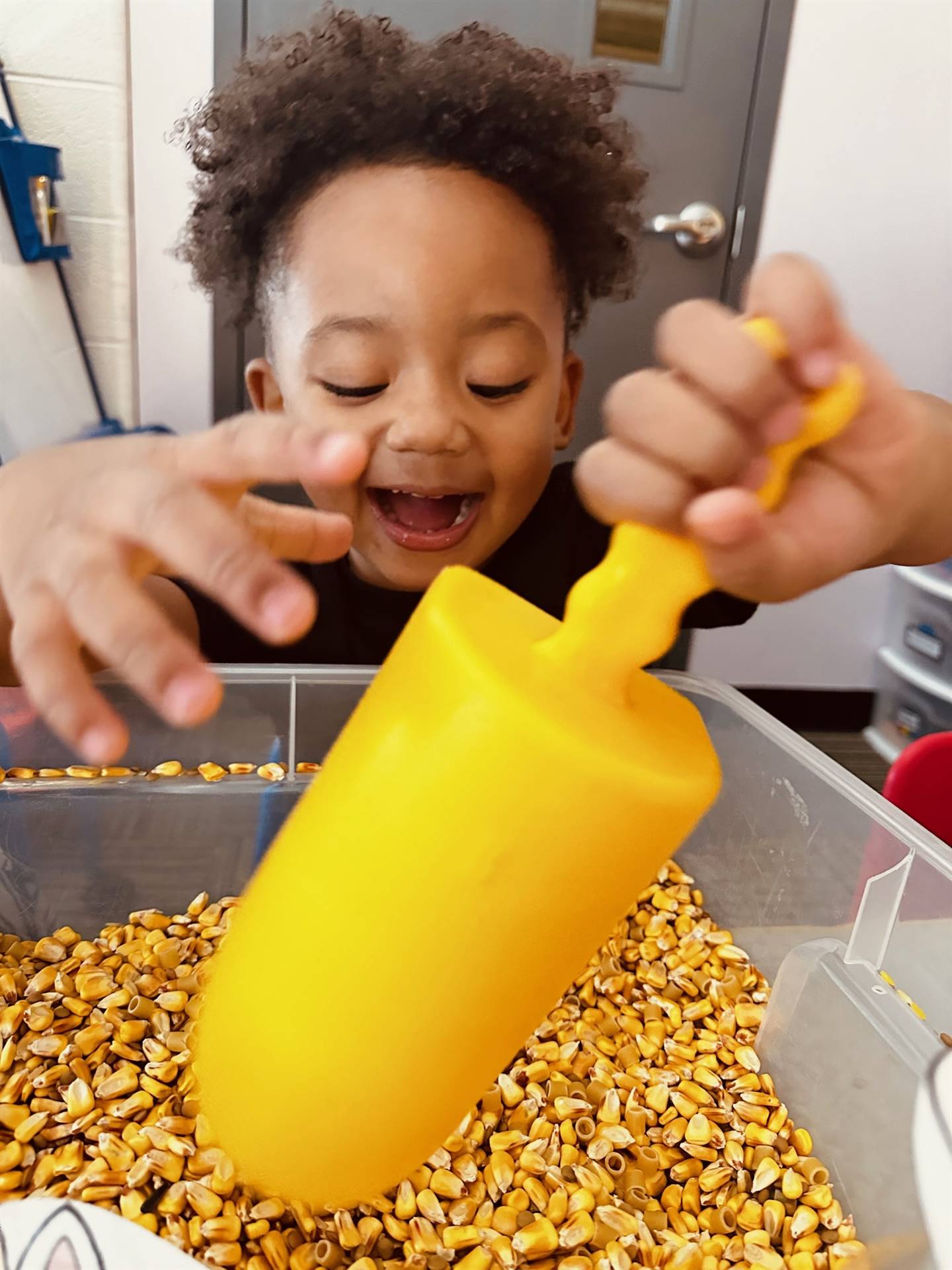 Student in sensory bin