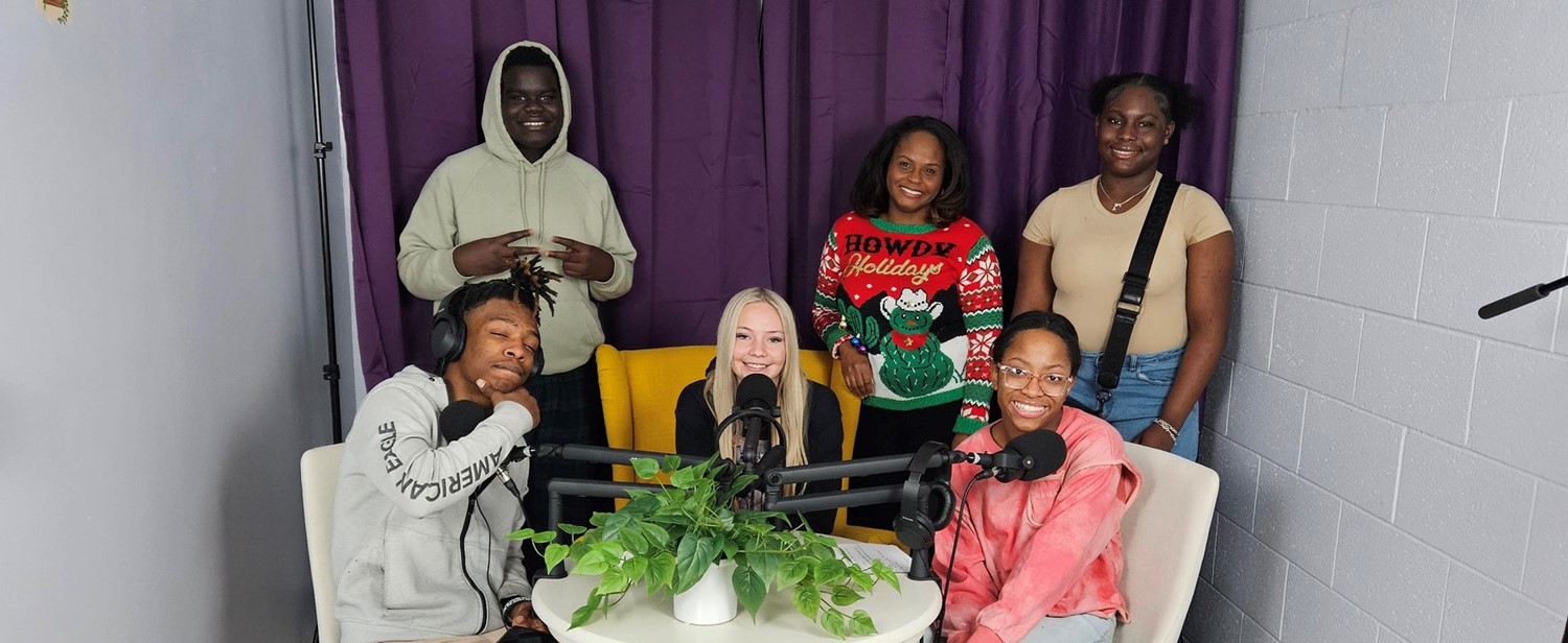 Raider Radio students posing for a group photo in their recording studio