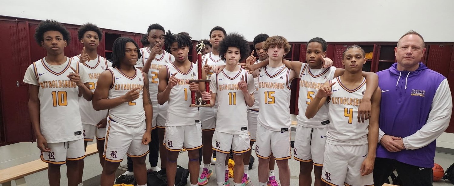 Freshman boys basketball team posing with a trophy