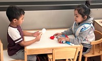 Preschool boys playing at the table. 